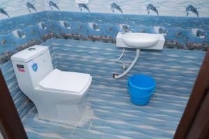 a bathroom with a toilet and a sink at Seven Endue Delight with Mountain view on the Hill Top in Ooty