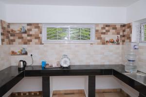 a kitchen with a counter top and a sink at Seven Endue Delight with Mountain view on the Hill Top in Ooty