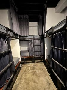 an empty room with two bunk beds and curtains at Cilacap Guest House in Cilacap