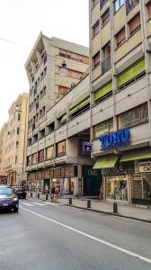 a large building with a sign on the side of a street at Grattacielo Apartment in Rapallo