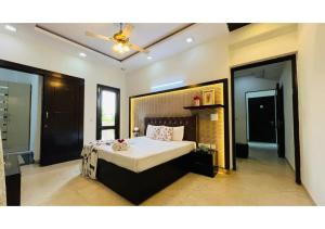 a bedroom with a bed and a ceiling fan at BluO Studio - M Block Mkt Greater Kailash in New Delhi