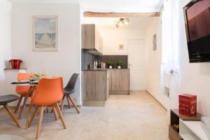 a kitchen and dining room with a table and chairs at LA PAIA - BRAND NEW FLAT 3 Guests OLD TOWN 5 min. from beach in Antibes +9 photos