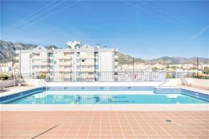 a swimming pool in front of a building at Beachfront Apartment Marbella Center in Marbella