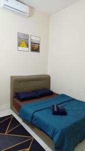 Postel nebo postele na pokoji v ubytování Telang Guest House Tasik Raban
