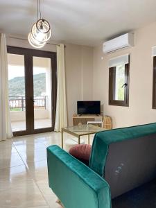 a living room with a couch and a table at Mons Apartments in Spílion