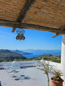 a patio with tables and chairs and a view of the ocean at Villa Paradiso in Piano Conte