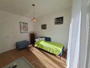 um quarto com uma cama com um cobertor verde em Bubi's apartment, intero appartamento di 65mq em Livorno