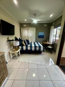 a living room with a bed and a tv at Granny Flat &Solar in Ramsgate