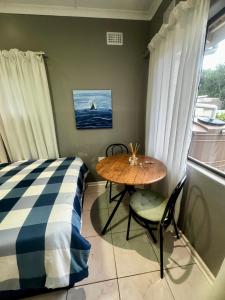 a table and chairs in a room with a window at Granny Flat &Yoga Studio in Ramsgate