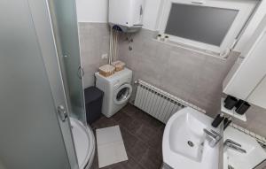 a small bathroom with a toilet and a sink at Apartman Nora in Mučići +15 photos