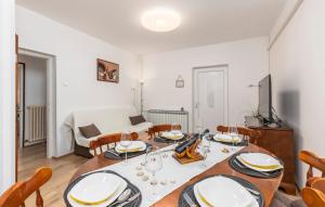a dining room with a table and chairs and a couch at Apartman Nora in Mučići