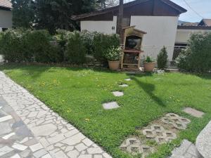 un patio con un jardín con una estatua en el césped en Stari Grad Apartment-free parking, en Sarajevo