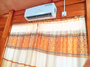 a air conditioner sitting on top of a window at Ella Green Cottages in Ella