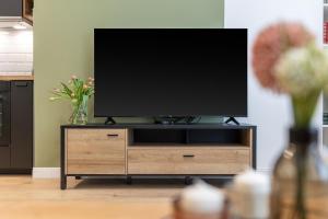 a flat screen tv sitting on top of a wooden entertainment center at Izabella66 apartment in Budapest