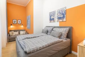 a bedroom with a bed and a couch at Izabella66 apartment in Budapest