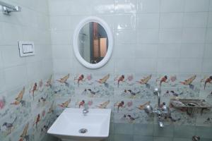 a bathroom with a sink and a mirror at Seven Endue Delight with Mountain view on the Hill Top in Ooty