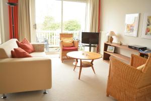 a living room with a couch and a table at DU121 - spacious apartment in the centre in Domburg