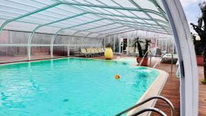 a swimming pool with a greenhouse and a swimming pool at Villa Giada Resort in Imperia