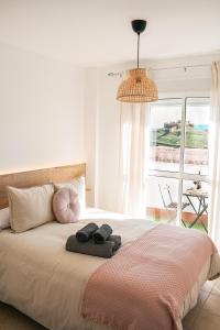a bedroom with a bed with two towels on it at Casita Molino de Erillas in Alora