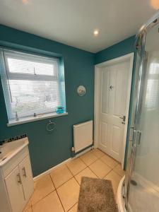 a bathroom with a shower and a glass door at Guest Suite in Porthleven With Private Garden in Helston