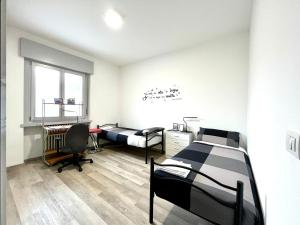 a room with two beds and a desk at [AlpinHome] Family & Friends in Trento