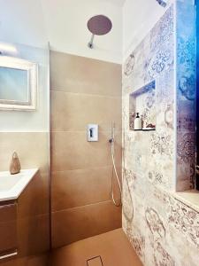 y baño con ducha y lavamanos. en IL MIRTO - Accogliente bilocale a Capo Testa - IUN R5566 en Capo Testa