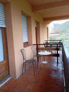 a balcony with chairs and tables on a balcony at La Cabana in Organyà