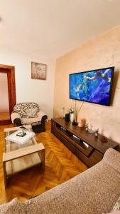 a living room with a large flat screen tv on the wall at Boka apartment in Kotor