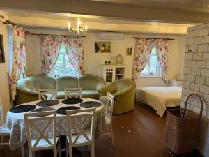 a living room with a bed and a table and chairs at Drewniany Domek w Zakątku Andrzeje Śniczany 18 in Sniczany