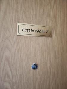 a sign on a wooden door that reads little room at Little room 7 - pokój z prywatną łazienką i aneksem in Szczecin