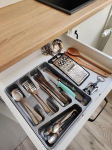 a tray with utensils in a kitchen drawer at Little room 7 - pokój z prywatną łazienką i aneksem in Szczecin +3 photos