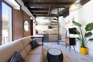 a living room with a couch and a staircase at Apartamentos Simba in Málaga