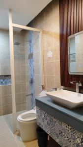 a bathroom with a toilet and a sink at Eagle Point Beach and Dive Resort in Mabini