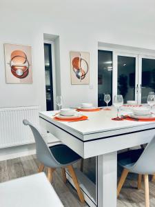 a dining room with a white table and chairs at Luxury Town Centre House, Faversham in Faversham
