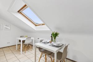 a dining room with white tables and chairs and a skylight at Zentrale, Große & Moderne Unterkunft in Koblenz in Koblenz