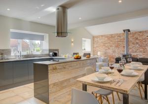 a kitchen and dining room with a table and chairs at Field View in Hindolveston