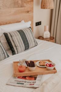 a tray of food sitting on top of a bed at Ostrako Beachside Suites in Agia Anna Naxos