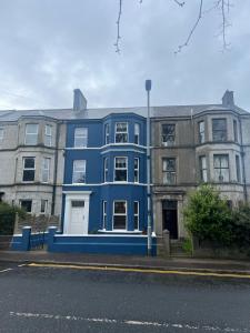 a blue building on the side of a street at Quay House, North Coast 6 bedroom holiday home in Ballycastle