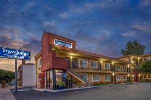 a hotel with a sign in front of a building at Travelodge by Wyndham Burbank-Glendale in Burbank