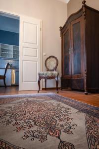 a room with a chair and a door and a rug at Altstadt Palais in Weimar