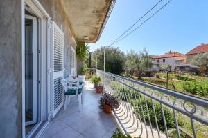 a balcony with a bench and a table on it at One bedroom apartment Dragica in Zadar