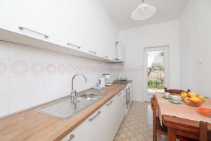 a kitchen with a sink and a table at One bedroom apartment Dragica in Zadar