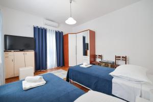 a hotel room with two beds and a tv at One bedroom apartment Dragica in Zadar