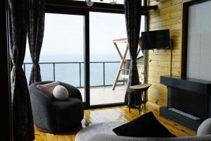 a living room with a view of the ocean at Venek Viila Suit in Pazar