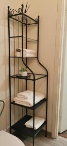 a black towel rack with white towels on it at Old Town Studio in Kaunas in Kaunas