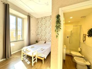 a bathroom with a bed and a bathroom with a sink at Casa Lina in Civitavecchia