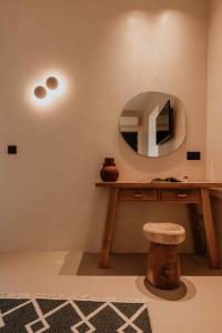 a room with a table with a mirror and a stool at Ostrako Beachside Suites in Agia Anna Naxos