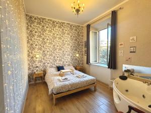 a bedroom with a bed and a tub and a sink at Casa Lina in Civitavecchia