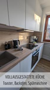 a kitchen with a sink and a counter top at Ferienwohnung Alpenflair mit Pool und Sauna & direkt am Skilift in Missen-Wilhams