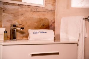 a bathroom with a sink and a towel at Blue Marine Guest Rooms in Lampedusa